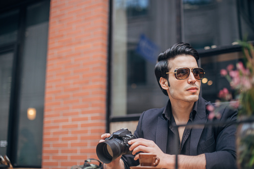 Portrait of handsome man with camera