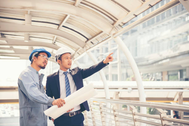 istock Business man building contractor using smart phone discussion at conference room. Architect Interior design. 1202022636