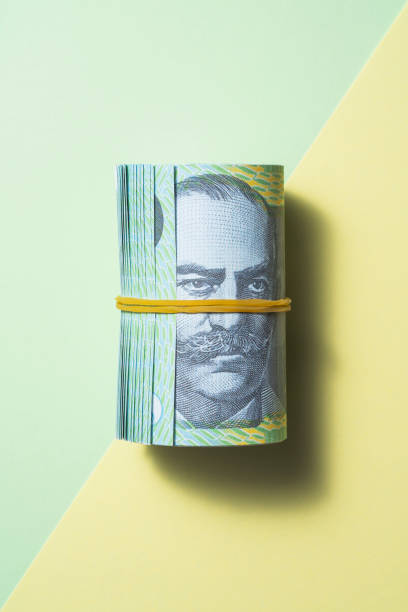 австралийский доллар катится на двухцветном цветном фоне - photography still life vertical bill стоковые фото и изображения