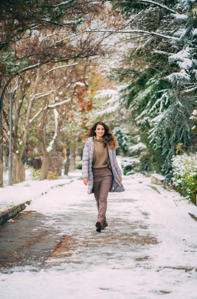 istock Happy Woman in Snowy Park 1202022909