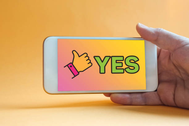 istock YES - Women with smart phone on hand, blurred background. 1202025266