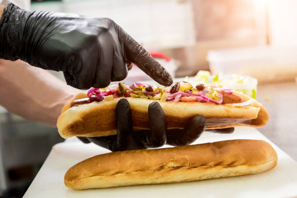 istock The chef cooking hot dog on a grill. Restaurant. 1202026516