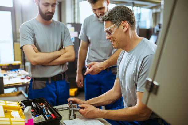 istock Male supervisor evaluate work in factory and writing at notepad 1202028191
