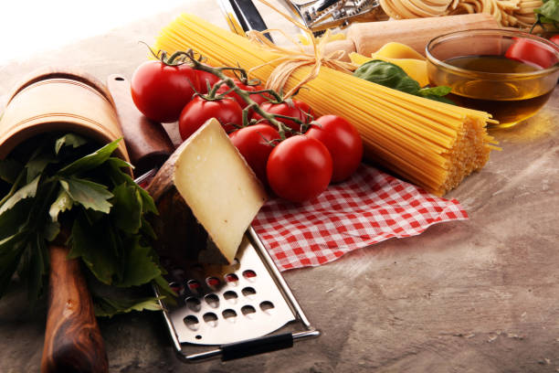 istock Pasta, vegetables, herbs and spices for Italian food on rustic table 1202028301