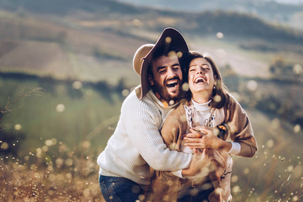 istock Young cheerful couple having fun in a meadow. 1202029007