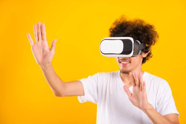 istock Asian handsome man with curly hair he using virtual reality headset or VR glass 1202029536