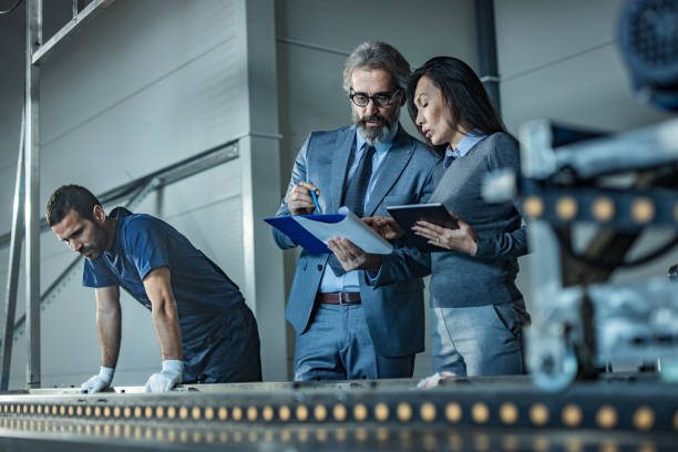 istock Quality control inspectors working on data and digital tablet in a production line. 1202029672