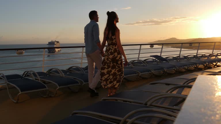 Couple on a romantic sunset walk on a cruise ship