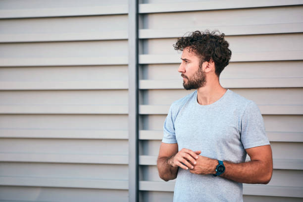 istock Young man exercising / stretching in urban area. 1202030665