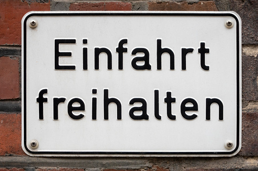 German road sign: Einfahrt freihalten (keep the entrance clear). Isolated on white, with clipping path