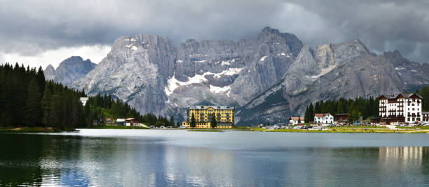 istock Beautiful Panorama at Misurina lake with Sorapiss Dolomitic Group on background and dramatic cloudy sky. Sexten Dolomites near Cortina d'Ampezzo, Italy. Europe. 1202036355