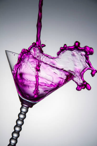 istock Purple Liquid Pouring Into Glass 1202036672