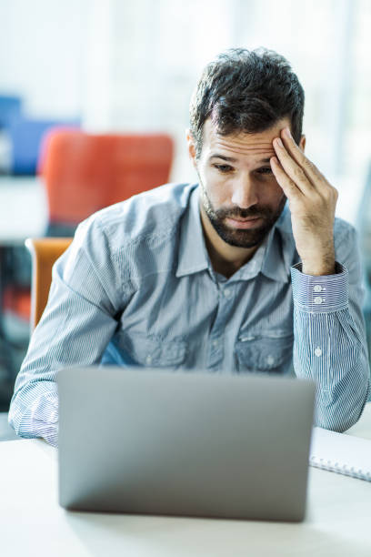 istock Worried entrepreneur brainstorming while working on laptop in the office. 1202039537