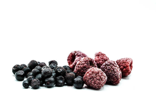 istock frozen blueberries and raspberries isolated on white background 1202041013