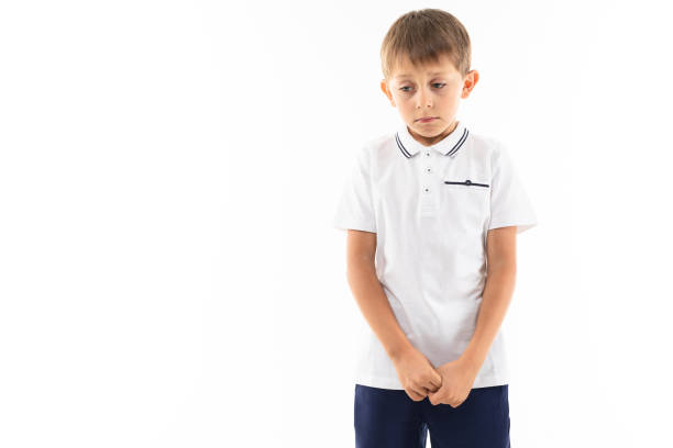 istock sad offended boy with bangs in a white t-shirt on a white background with copy space 1202041095