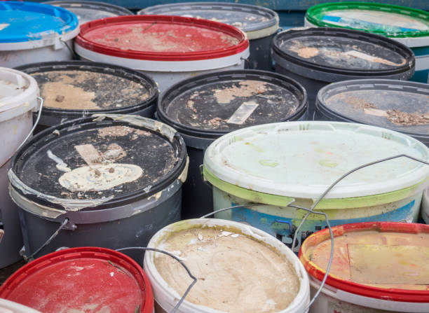 istock Old paint buckets industry background 1202041836