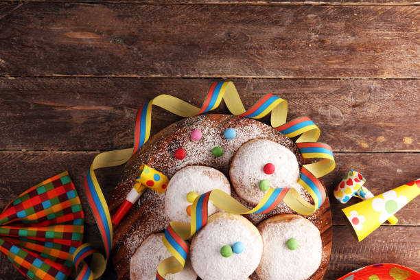 istock Carnival powdered sugar raised donuts with paper streamers. German berliner or krapfen for carnival 1202042107