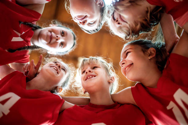 istock Female  School Basketball Team Playing Game 1202043103