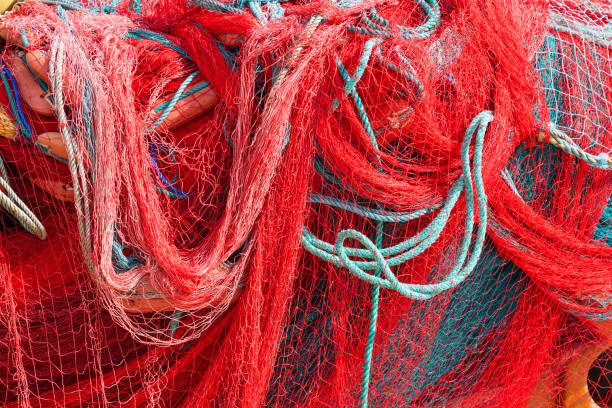 istock Red Fishing Net Pile Background Texture 1202043199