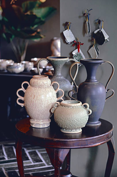 istock Amphora vase set in interior. Decorative ceramic pottery in a art store. 1202045071