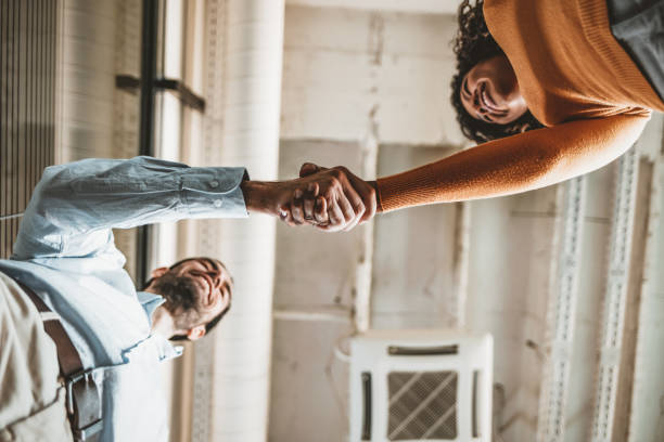 Two people shaking hands Sealing a deal! Two Business people shaking hands after Welcoming partners finishing up a meeting or setting goals and planning way to success in the office. employee introduction stock pictures, royalty-free photos & images