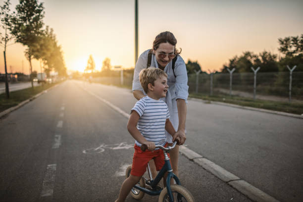 istock Mom teaching her son biking 1202046644