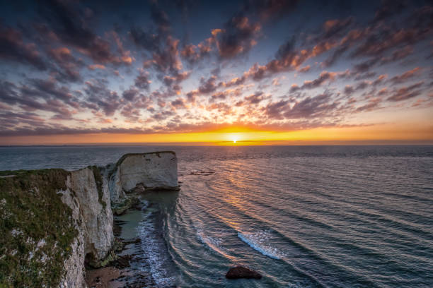 Sunset over Old Harry Rocks, Jurassic Coast, Dorset, England Stunning sunset over the famous Old Harry Rocks, situated on the Jurassic Coast, Dorset, England old harry rocks stock pictures, royalty-free photos & images