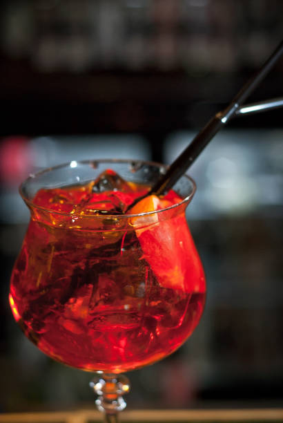 istock Red cocktail on bar counter. Drink with martini, gin, rum, tequila and fruit. 1202049067