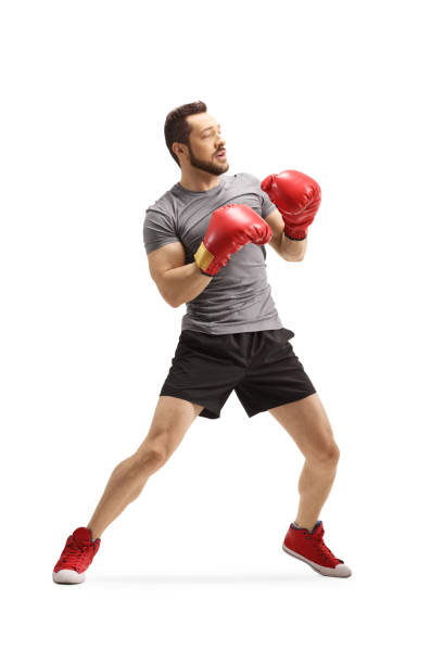 istock Young man with boxing gloves standing in a guard position 1202050038