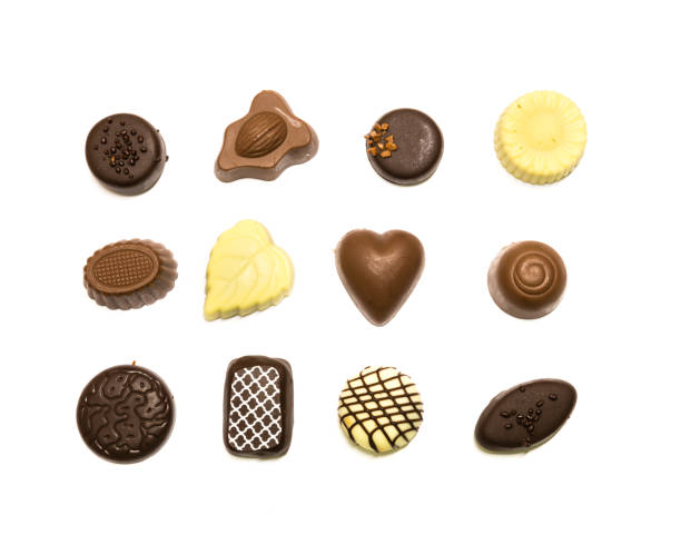istock Studio shot chocolate pralines display in three rows decoration isolated on white top view 1202050156