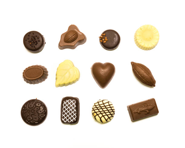 istock Studio shot chocolate pralines display in three rows decoration isolated on white top view 1202050165