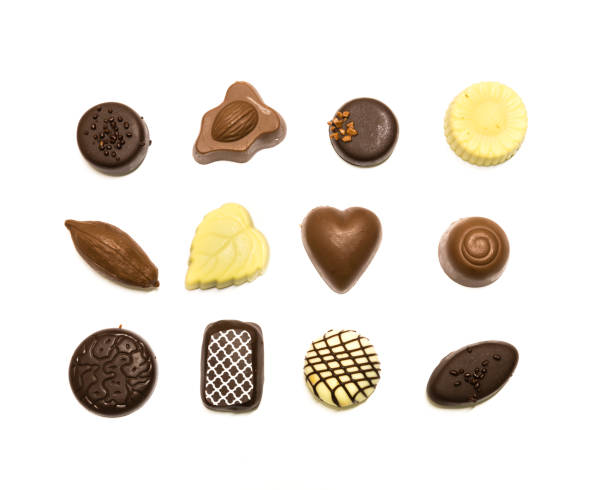 istock Studio shot chocolate pralines display in three rows decoration isolated on white top view 1202050169