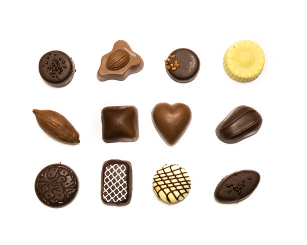 istock Studio shot chocolate pralines display in three rows decoration isolated on white top view 1202050175