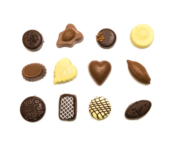 istock Studio shot chocolate pralines display in three rows decoration isolated on white top view 1202050187