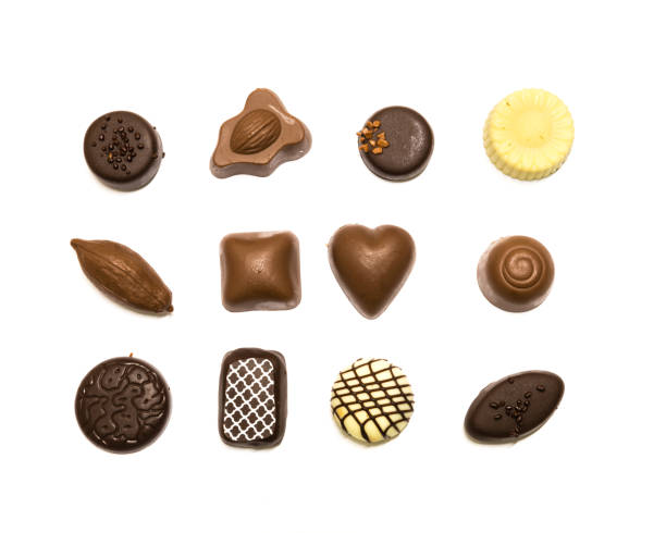 istock Studio shot chocolate pralines display in three rows decoration isolated on white top view 1202050198