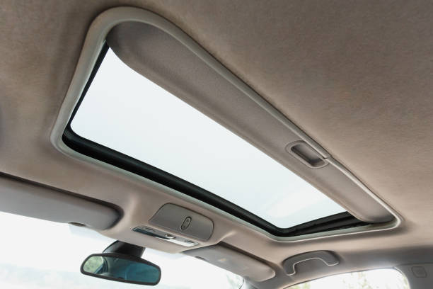 istock Automotive sunroof close up, white ceiling 1202051154