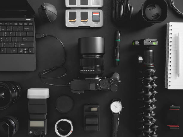 istock top view of work space photographer with digital camera, flash, cleaning kit, memory card, tripod and camera accessory on black table background 1202052756