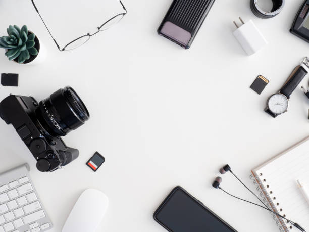 istock top view of photographer work station, work space concept with digital camera, memory card, keyboard and smartphone on white table background 1202052768