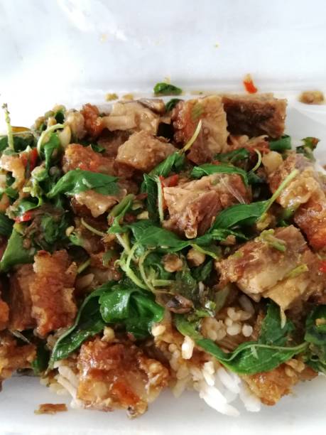 istock Stir Fried crispy pork with basil leaves  - Thai food 1202053748