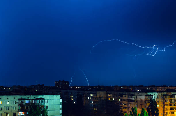istock Thunderstorm with lightning and thunder over the night city 1202053779