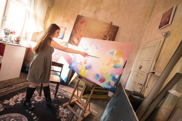 istock Young Woman Painter Enjoy Working in her Studio 1202055410