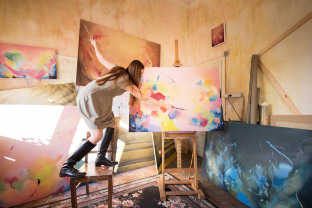 Young Woman Painter Enjoy Working in her Studio stock photo