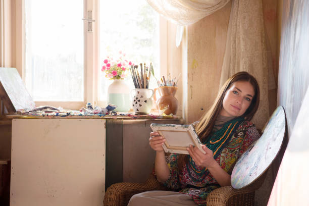 istock Beautiful Woman Painter in her Art Studio 1202055483