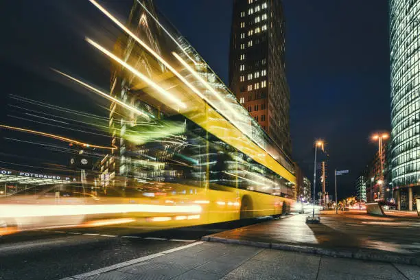 long exposure of yellow bus at blue hour on Potsdamer Platz in Berlin