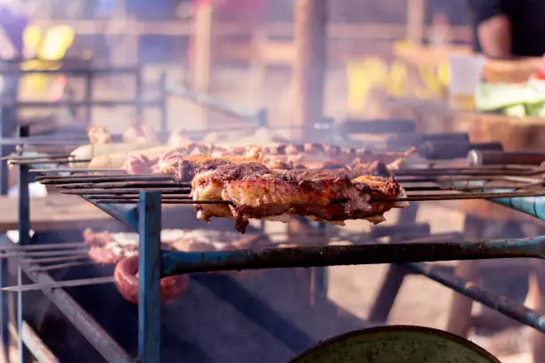 Photo of Barbecuing gaucho roasting on fire, churrasco, semana Farroupilha.