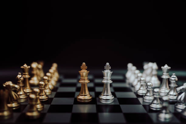istock Business competition and strategy plan concept. Chess board game gold and silver colour 1202057525