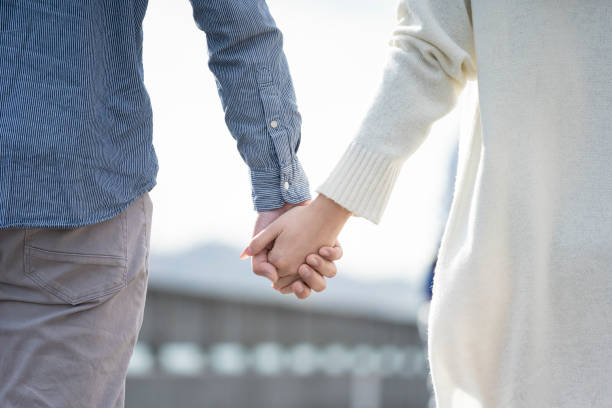 Hands of a young couple holding hands