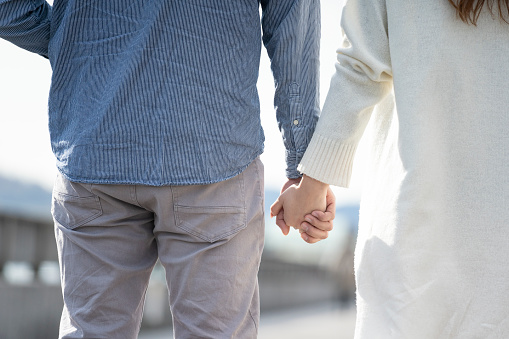 Hands of a young couple holding hands