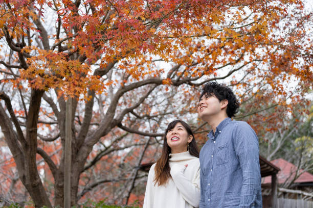istock Young couple enjoying autumn leaves hunting 1202058564