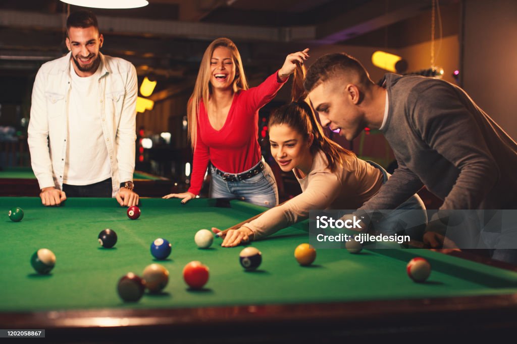 Group Of Friends Play Billiards At Night Out Stock Photo - Download Image  Now - Snooker, Adult, Adults Only - iStock